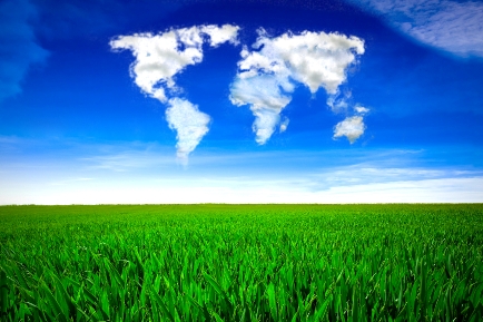 Cloud formation in the shape of a map of the world, over a green field